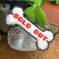 vintage belt buckle with floral/paisley design