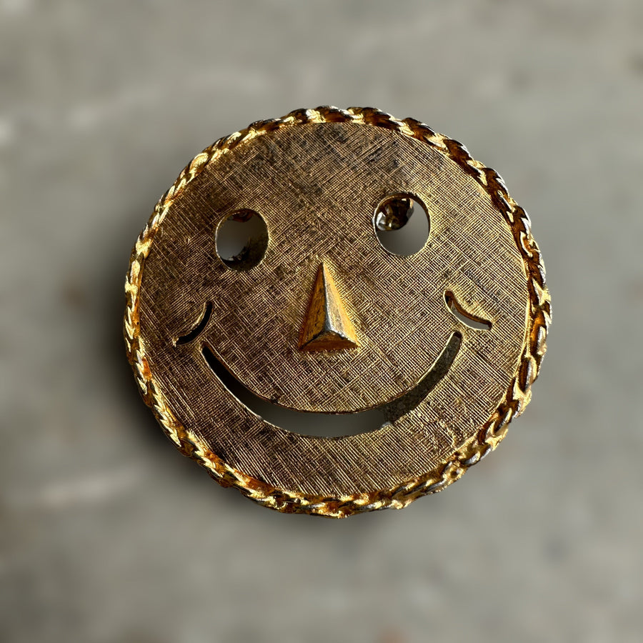 vintage smiley face brooch and pendant with articulated rhinestone eyes